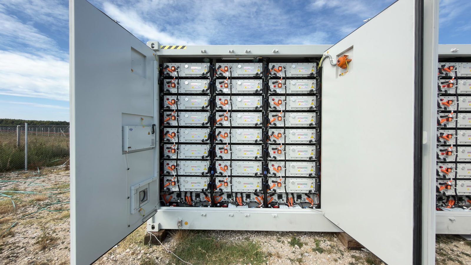 Open Crostorion battery container showing the full rack stack